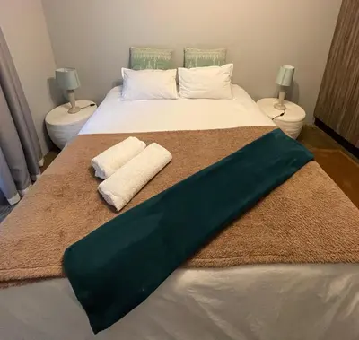 a bedroom with a bed with two towels on it at The Lion Mansion - on Solar live and work anywhere in Pretoria