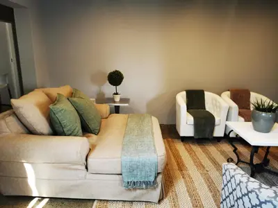 a living room with a couch and a chair at The Lion Mansion - on Solar live and work anywhere in Pretoria