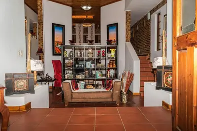 a room with a couch and a shelf of items at Mereke Manor in Centurion