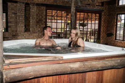 a man and a woman in a bath tub at Mereke Manor in Centurion