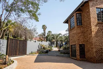 a brick house with a gate on the side of it at Mereke Manor in Centurion