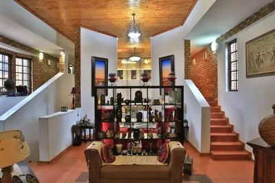 a room with a shelf filled with bottles of wine at Mereke Manor in Centurion