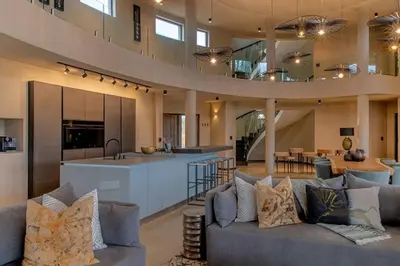 an open kitchen and living room in a house at Luxury Villa looking onto Kruger National Park in Belfast