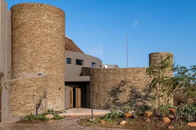 a large brick building with two tall towers at Luxury Villa looking onto Kruger National Park in Belfast