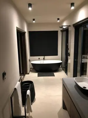 a bathroom with a large tub and a sink at Luxury Villa looking onto Kruger National Park in Belfast