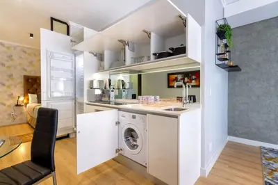 a kitchen with a washing machine in a room at Alimama Spaces: The Manson Newton Villa Ellipse in Midrand