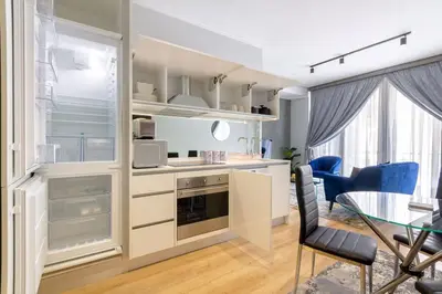 a kitchen and dining room with a table and chairs at Alimama Spaces: The Manson Newton Villa Ellipse in Midrand