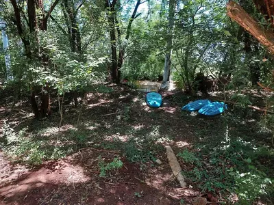 two blue bags on the ground in the woods at Vulture's View 3 in Hartbeespoort
