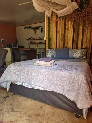 a bedroom with a large bed with towels on it at Vulture's View 3 in Hartbeespoort