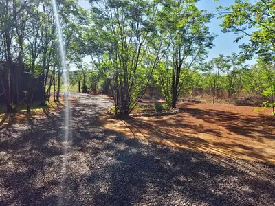 a fire hydrant in the middle of a field with trees at Vulture's View 3 in Hartbeespoort