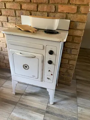 a white stove with a bowl on top of it at Sunset Guesthouse and Venue Cullinan in Meule