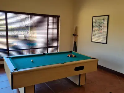 a pool table in a living room with at Zebula No 2 Waterbergs Over the Savannah 4 Bedroom in Mabula
