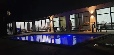 a house with a swimming pool at night at Marloth Park, Kruger safari house - solar in Marloth Park