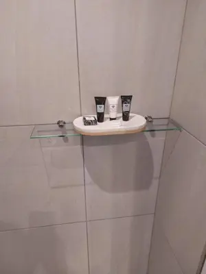 two cups sitting on a glass shelf in a room at 317 Menlyn Maine Trilogy in Pretoria