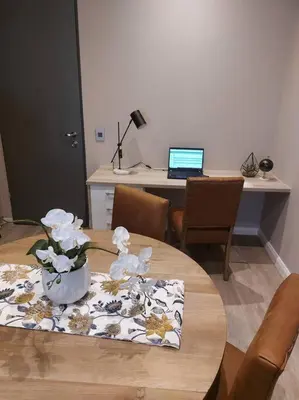 a table with a vase of flowers on top of it at 317 Menlyn Maine Trilogy in Pretoria