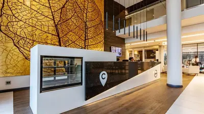 an apple store with a large wall mural in a building at 317 Menlyn Maine Trilogy in Pretoria