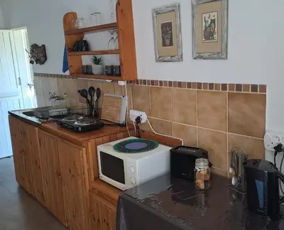 a kitchen with a microwave on top of a counter at In Da Bush in Modimolle
