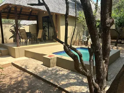 a house with a swimming pool next to a house at Athule Inn Marloth - Units in Marloth Park