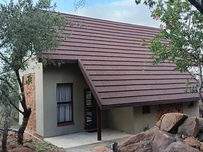 a small house with a red roof at Eclectic Safari Lodge in Mabula