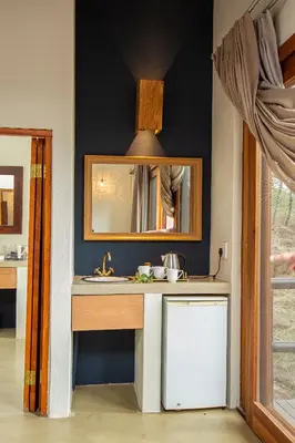a kitchen with a sink and a mirror at Eclectic Safari Lodge in Mabula