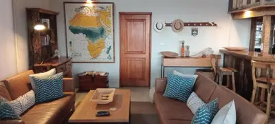 a living room with a couch and a table at Eclectic Safari Lodge in Mabula