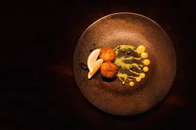 a plate of food with potatoes and vegetables on a table at Shibula Safari Lodge in Welgevonden Game Reserve