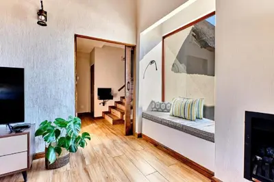 a living room with a couch and a fireplace at Nyala View, Mabalingwe in Mabula
