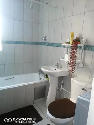 a bathroom with a sink and a toilet and a tub at Private Room Chez Khanyi Homestays in Pretoria