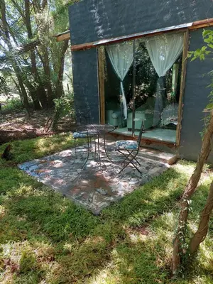 a table and chairs in front of a house at Vulture's View 2 in Hartbeespoort