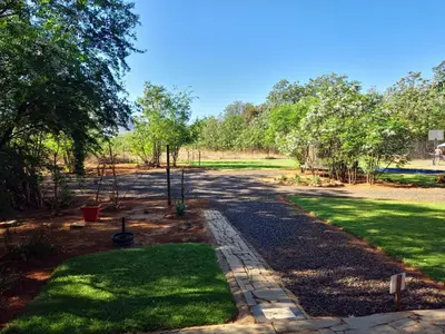 a walkway in a yard with grass and trees at Vulture's View 2 in Hartbeespoort
