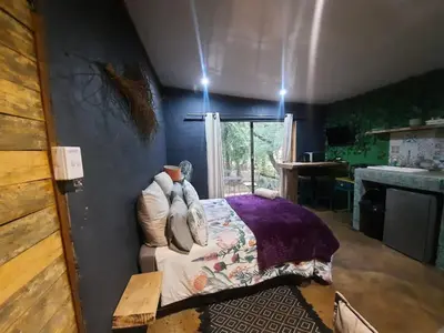 a bedroom with a bed with pillows on it at Vulture's View 2 in Hartbeespoort