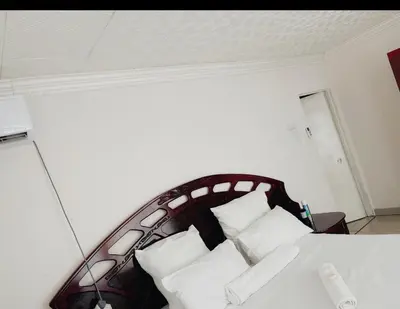 a bedroom with a bed with white pillows at Motjatji B&B in Burgersfort
