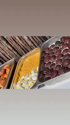 a table with three trays of different types of food at Motjatji B&B in Burgersfort