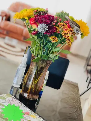 a vase filled with flowers sitting on a table at Motjatji B&B in Burgersfort