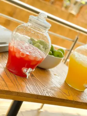 a bottle of drink on a table with a bowl of fruit at Motjatji B&B in Burgersfort