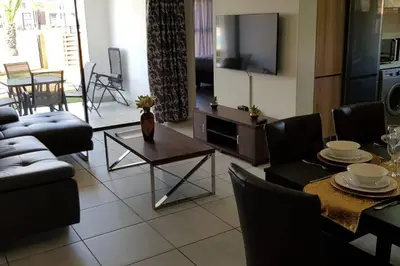 a living room with a couch and a table at Crystal lagoon View 3Bed Apartment in Pretoria