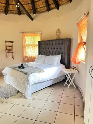 a bedroom with a large bed in a room at Indlovu Inn Guesthouse in Graskop