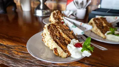 two plates of food on a wooden table at Vida Nova Kruger in Marloth Park