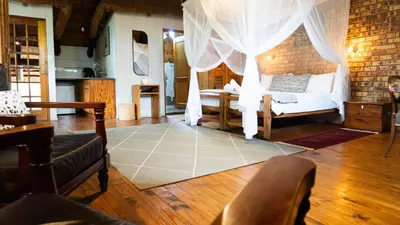 a living room with a bed with a curtain at Vida Nova Kruger in Marloth Park