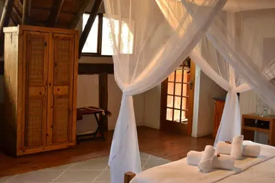 a bedroom with a bed with a canopy at Vida Nova Kruger in Marloth Park