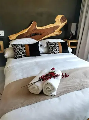 a bedroom with a bed with two towels on it at The Blyde Apartment 1287 in Pretoria