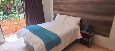 a bedroom with a bed and a window at The Crooked Forest in Pretoria
