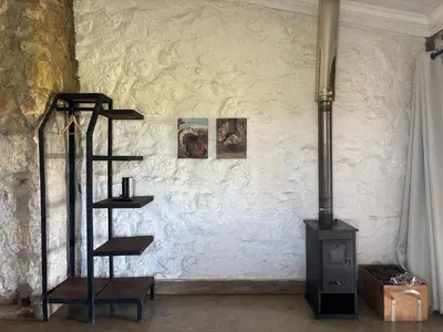 a brick wall with a wood stove in a room at La Vista Farm Stay in Ermelo