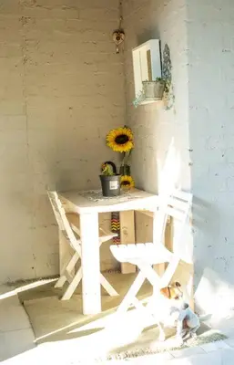 a small white desk with a dog sitting next to it at HomeSweetHome Farm Cottage in Nelspruit