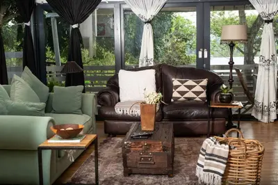 a living room with a couch and a table at HomeSweetHome Farm Cottage in Nelspruit