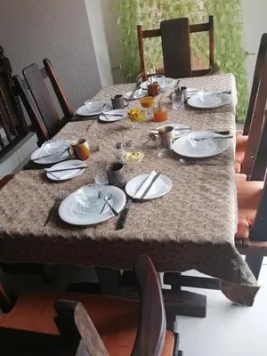 a long table with plates and utensils on it at THEE VIEW in Hartbeespoort