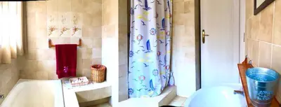 a bathroom with a toilet and a shower curtain at THEE VIEW in Hartbeespoort