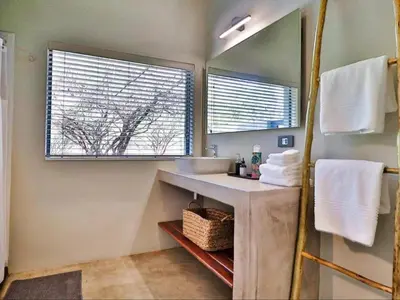 a bathroom with a sink and a mirror at Chelesa by Kruger Nights in Marloth Park