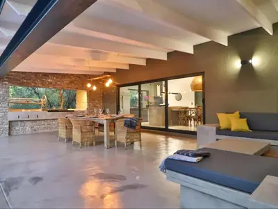 a living room with a blue couch and a table at Chelesa by Kruger Nights in Marloth Park