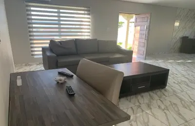 a living room with a couch and a coffee table at Yami Nawe Lodge in Dennilton